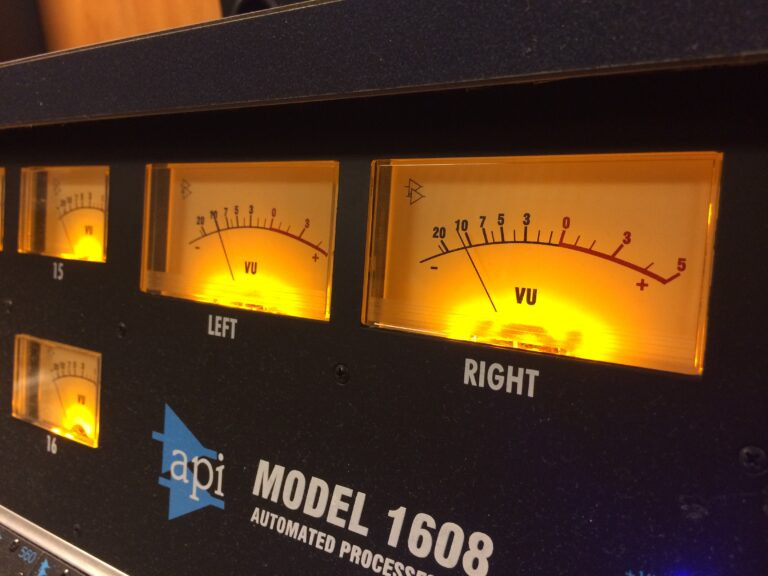 API 1608 recording console VU meter bridge showing needle meters above the mixing board